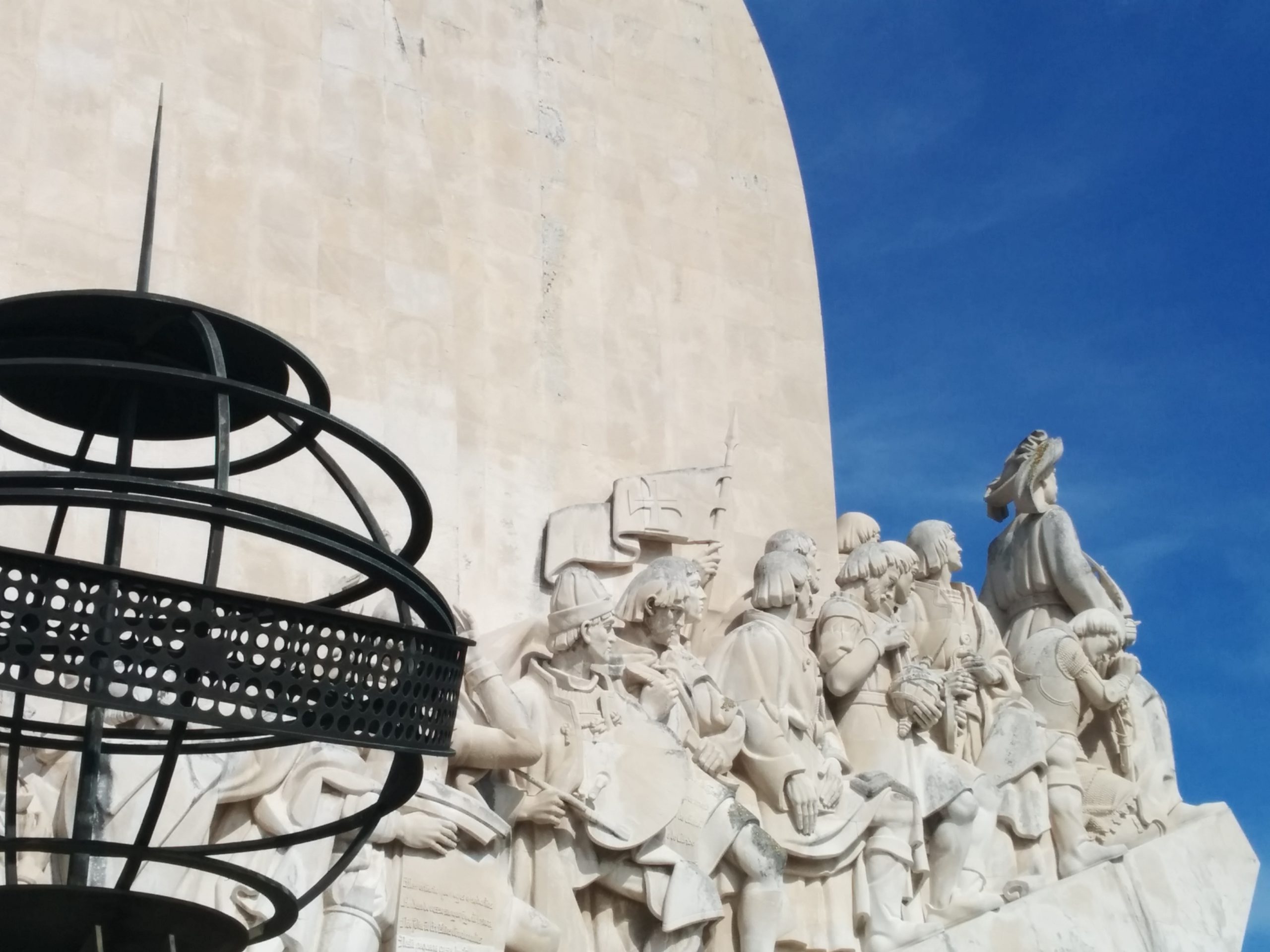 The Monument to the Discoveries (Padrão dos Descobrimentos) in Lisbon, Portugal, photographed from below against a blue sky