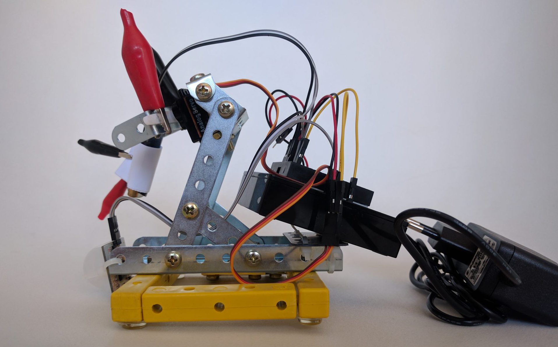 The Mythos Entertainment System 1 device: a laser pointer and infrared motion sensor mounted on a servo arm, wired to an Arduino.